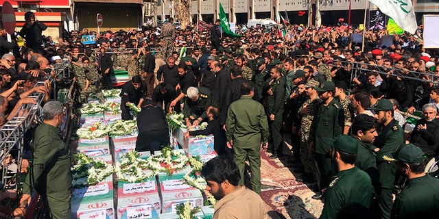 Caskets of those who died in an attack on a military parade in Iran are displayed in Ahvaz, Iran on Monday.