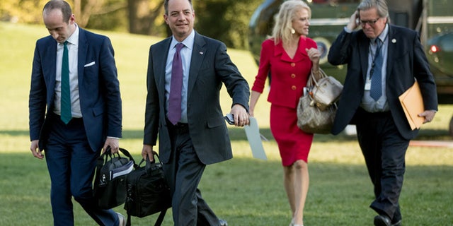 From left, President Donald Trump's White House Senior Adviser Stephen Miller, President Donald Trump's Chief of Staff Reince Priebus, Counselor to the President Kellyanne Conway, and President Donald Trump's White House Senior Adviser Steve Bannon, walk across the South Lawn after President Donald Trump arrives at the White House in Washington, Tuesday, April 18, 2017, after a short trip from Andrews Air Force Base, Md., after speaking at Snap-On Tools in Kenosha, Wis. (AP Photo/Andrew Harnik)