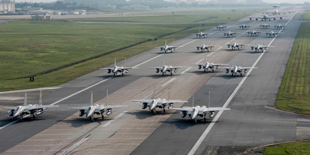 U.S. Air Force 44th and 67th Fighter Squadron F-15 Eagles and 961st Airborne Air Control Squadron E-3 Sentries taxi down the runway.