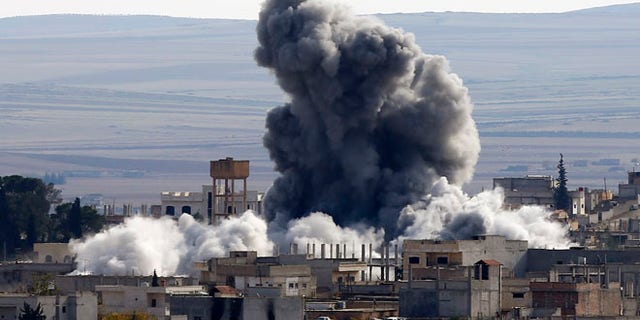Nov. 23, 2014: An explosion following an air strike is seen in Kobani, Syria, near the Turkish border.