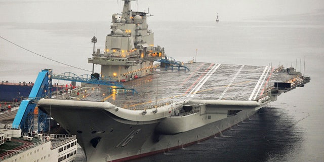 FILE 2012: China's first aircraft carrier, which was renovated from an old aircraft carrier that China bought from Ukraine in 1998, is seen docked at Dalian Port.