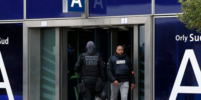 French elite police forces patrol at the Orly airport departure terminal, south of Paris, Saturday, March, 18, 2017. A man was shot dead Saturday after wrestling a soldier to the ground at Paris' Orly Airport and trying to take her rifle, officials said. No one else in the busy terminal was hurt, but thousands of travelers were evacuated and flights were diverted to the city's other airport. (AP Photo/Thibault Camus)