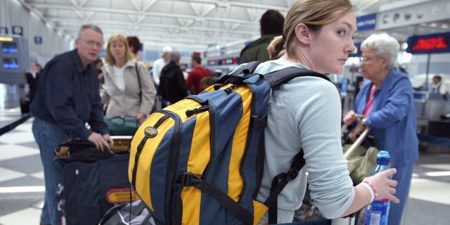 CHICAGO, IL - MAY 21: Travelers stand in line at the United Airlines Terminal at O'Hare International Airport May 21, 2003 in Chicago, Illinois. The airlines said that it is weighing whether to emerge from bankruptcy months ahead of schedule. Analysts say the company has obstacles to overcome before it can operate outside of court protection. (Photo by Tim Boyle/Getty Images)
