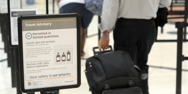 In this Aug. 3 photo, airline passengers go through the Transportation Security Administration security checkpoint at Hartsfield-Jackson Atlanta International Airport.