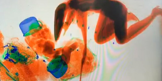 X-Ray images show the woman kneeling on all fours amongst the heap of luggage as she rides through with her purse, which she reportedly wanted to “guarantee” stayed safe.