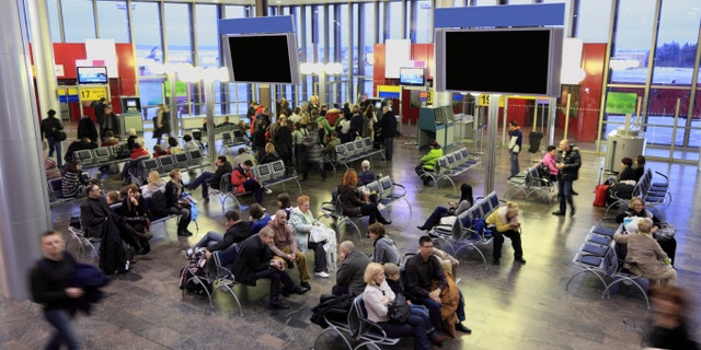 MOSCOW - DECEMBER 29: People in the waiting room at the airport Sheremetyevo, December 29, 2009, Moscow, Russia. Sheremetyevo - one of the largest Russian airports on the number of scheduled international traffic.