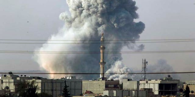 Oct. 14, 2014: Smoke rises following an airstrike by the U.S.-led coalition in Kobani, Syria as fighting continues between Syrian Kurds and the militants of Islamic State group, as seen from Mursitpinar, on the outskirts of Suruc, at the Turkey-Syria border. Kobani, also known as Ayn Arab, and its surrounding areas, has been under assault by extremists of the Islamic State group since mid-September and is being defended by Kurdish fighters.