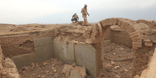 November 16, 2016: A member of the Iraqi army walks at the remains of wall panels and colossal statues of winged bulls, destroyed by Islamic State militants in the Assyrian city of Nimrud, south of Mosul, Iraq.
