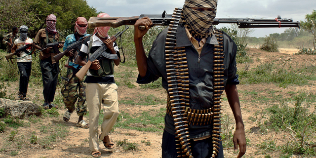 Al-Shabaab fighters seen walking along a trail in Somalia.