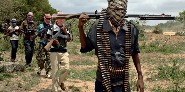 Al-Shabaab fighters seen walking along a footpath in Somalia.