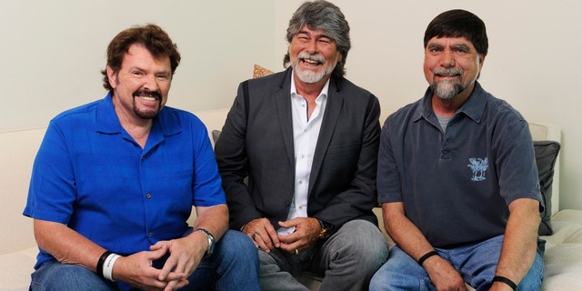 In this Tuesday, Aug. 13, 2013 photo, Jeff Cook, Randy Owen and Teddy Gentry from the American country music band Alabama pose for a portrait in Nashville, Tenn. Alabama has launched a tour and released a new album this week, “Alabama & Friends,” that features duets of the group’s biggest hits with top country stars.