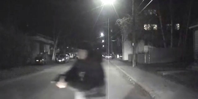 An image from video provided by the Fairbanks Police Department shows shows the suspect police believe abandoned a police car he stole after he shot an officer in Fairbanks, Ak., early Sunday, Oct. 16, 2016.