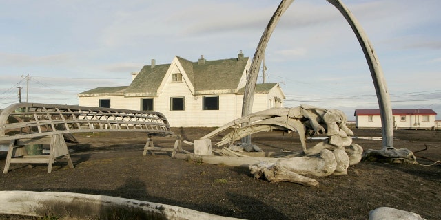 ILE - In this Aug. 12, 2005, file photo. a skin boat display sits next to whale bones and an arch made of a whale jaw on the beach at Brower's Cafe in Barrow, Alaska.