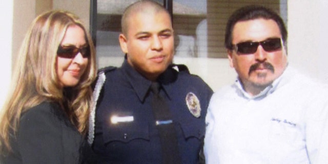 Officer Albert Covarrubias Jr. flanked by his father, Albert Sr., and his step-mother, Chela, on the day four years ago that he graduated from the police academy.