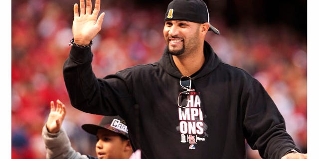 ST. LOUIS, MO - OCTOBER 30: First baseman Albert Pujols of the St. Louis Cardinals waves to the crowd during the World Series victory parade for the franchise's 11th championship on October 30, 2011 in St Louis, Missouri. The three-time MVP signed with the Los Angeles Angels of Anaheim on Dec. 8, 2011. (Photo by Ed Szczepanski/Getty Images)