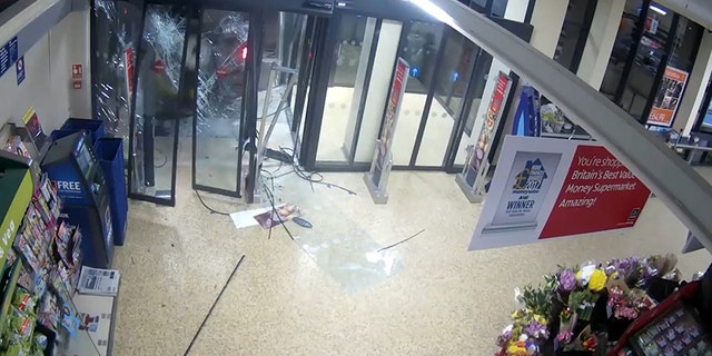The ATM can be seen near the door as the Land Rover starts to smash through.