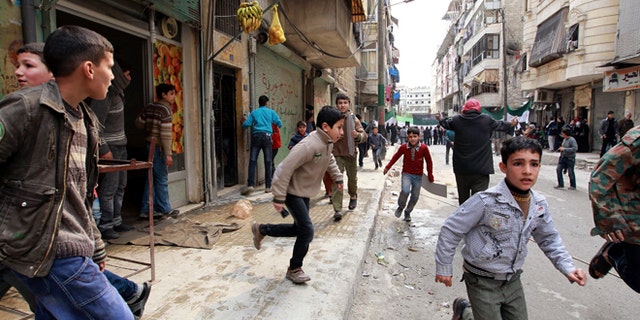 Feb. 22, 2013: People run upon hearing a nearby plane bombing during a protest against Syrian President Bashar al-Assad in the al-Katerji Tariq district in Aleppo.