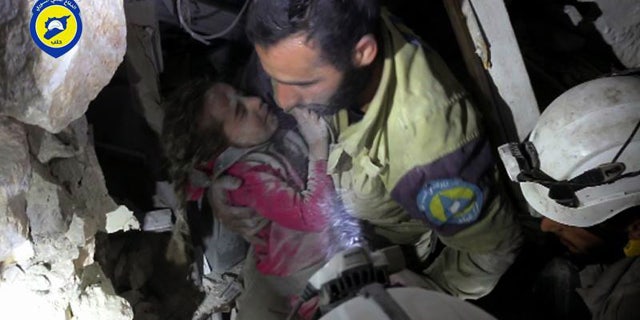 Sept. 28, 2016: This photo provided by the Syrian Civil Defense group known as the White Helmets shows a Civil Defense worker carrying Ghazal Akhtarini from under the rubble after airstrikes hit the al-Shaar neighborhood in Aleppo, Syria.