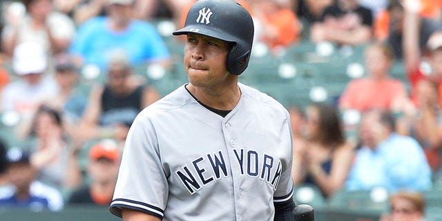 New York Yankees designated hitter Alex Rodriguez (13) walks off the field after striking out during the first inning against the Baltimore Orioles at Oriole Park at Camden Yards.