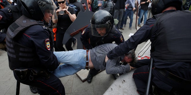 A protester is detained by riot police during an anti-corruption protest organized by opposition leader Alexei Navalny, on Tverskaya Street in central Moscow, Russia June 12, 2017.