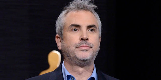FILE - In this Jan. 15, 2015 file photo, Alfonso Cuaron announces the Academy Awards nominations at the 87th Academy Awards nomination ceremony in Beverly Hills, Calif. Cuaron's new project will take on a year in the life of a middle class family in Mexico City in the early 1970s. It will be his first film since Gravity which won seven Oscars in 2014, including Best Director. (Photo by Dan Steinberg/Invision/AP, File)