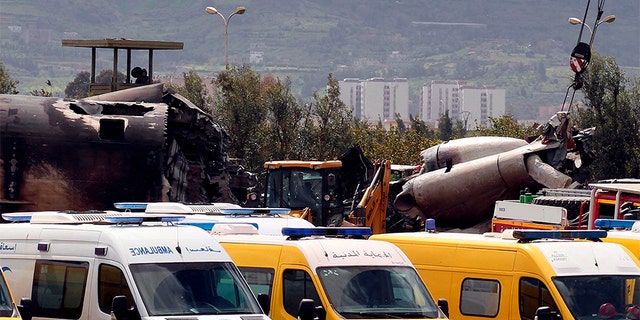 April 11, 2018: Firefighters and civil security officers work at the scene of the crash.