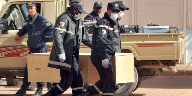 Jan. 21, 2013: Algerian firemen carry a coffin containing a person killed during the gas facility hostage situation at the morgue in Ain Amenas, Algeria.