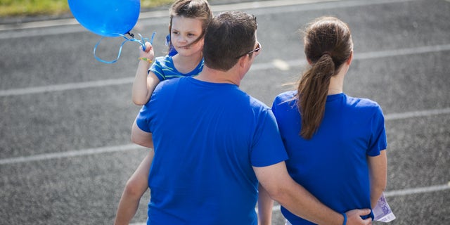 Matt and Melissa Graves, with daughter Ella, speak to supporters.