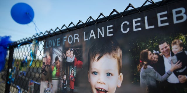 Banners hang on display with blue balloons and ribbons during a celebration of Lane Graves.