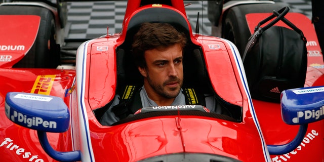 Fernando Alonso being fitted for an IndyCar at Barber Motorsports Park in Alabama on April 23.