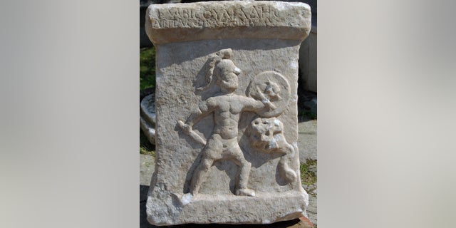 This marble altar, dating to the second century A.D., was discovered near the Akçay River in Turkey. It shows a nude warrior battling a serpent monster. An inscription written in Greek is at top.