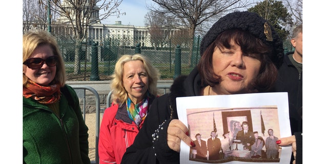Cheryl Rhoads holds a picture of a young Billy Graham with her grandparents.
