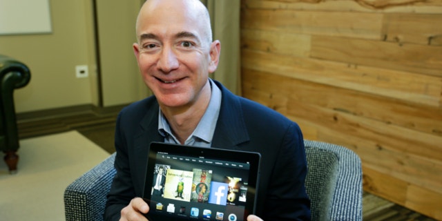 Sept. 24, 2013: Jeff Bezos, CEO of Amazon.com, poses for a photo with the 8.9-inch version of the new Amazon Kindle HDX tablet computer in Seattle.