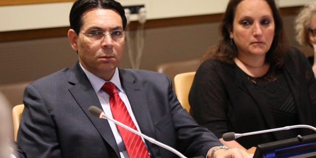 Israel's UN Amb. Danny Danon with Ruth Schwartz, whose son was killed in Israel, during a UN forum on Wednesday.