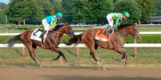 Aug. 29, 2015: Keen Ice , right, with Javier Castellano, right, slows after winning the Travers Stakes ahead of American Pharoah, with jockey Victor Espinoza, at Saratoga Race Course in Saratoga Springs, N.Y.