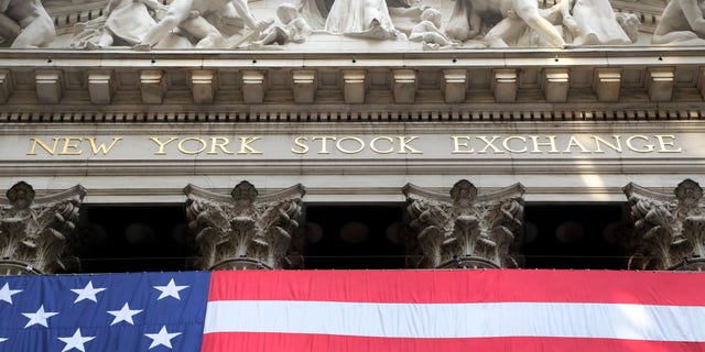 FILE -- July 6, 2015:  An American flag is draped on the exterior of the New York Stock Exchange.  (AP Photo/Mark Lennihan)