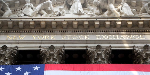 FILE -- July 6, 2015: An American flag is draped on the exterior of the New York Stock Exchange. (AP Photo/Mark Lennihan)
