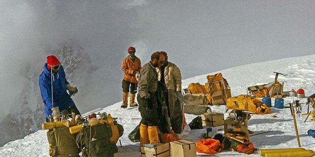 In this 1963 photo released by Henry S. Hall, Jr. American Alpine Club Library, Barry Corbet Personal Papers and Films, members of the 1963 American Mount Everest Expedition team and sherpas are shown with their climbing gear on Mt. Everest.