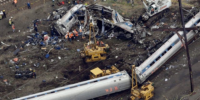 FILE In this May 13, 2015, file photo, emergency personnel work near the wreckage of a New York City-bound Amtrak passenger train following a derailment that killed eight people and injured about 200 others in Philadelphia. The state's attorney general has a wide range of options in responding to a judge's order to arrest a speeding Amtrak engineer involved in the deadly 2015 crash, a law professor said Friday, May 12, 2017. (AP Photo/Patrick Semansky, File)