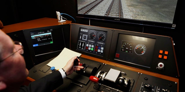 Metrolink Director of Operations, R.T. McCarthy, demonstrates Metrolink's implementation of Positive Train Control (PTC) at the Metrolink Locomotive and Cab Car Simulators training facility in Los Angeles' Union Station. Amtrak is considering suspending service on tracks that don't have sophisticated speed controls by a Dec. 31, 2018 deadline.