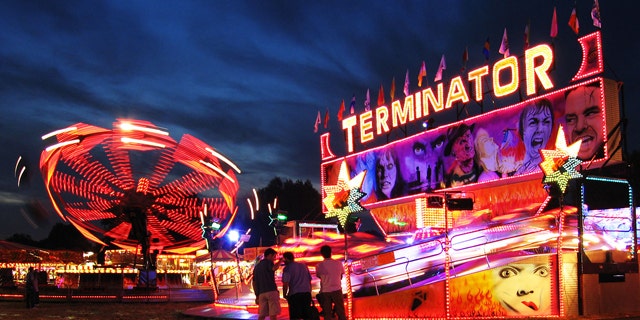 Rides glow at night at the Cambridge Midsummer Fair amusement park.