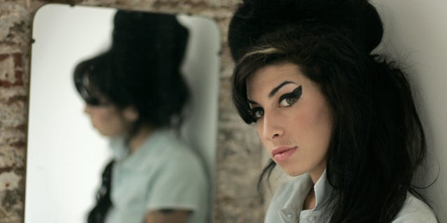 British singer Amy Winehouse wearing a beehive hairdo