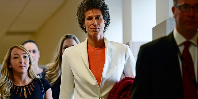 Andrea Constand, center, walks into a courtroom for Bill Cosby's sexual assault trial at the Montgomery County Courthouse, Friday, April 13, 2018, in Norristown, Pa.  Constand, Bill Cosby's chief accuser, will take the witness stand on Friday.
