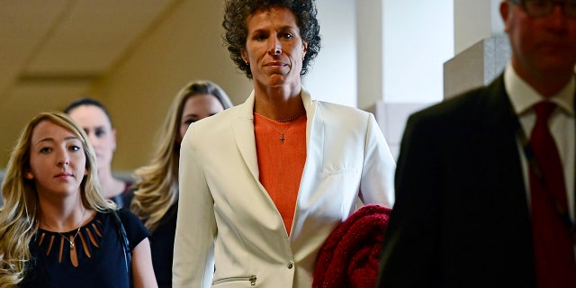 Andrea Constand, center, walks into a courtroom for Bill Cosby's sexual assault trial at the Montgomery County Courthouse, Friday, April 13, 2018, in Norristown, Pa. Constand, Bill Cosby's chief accuser, will take the witness stand on Friday.