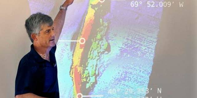 OceanGate CEO and co-founder Stockton Rush speaks in front of a projected image of the wreck of the ocean liner SS Andrea Doria during a presentation on Monday, June 13, 2016, in Boston, of findings after an undersea exploration earlier this month of the wreck in the Atlantic Ocean near Nantucket.