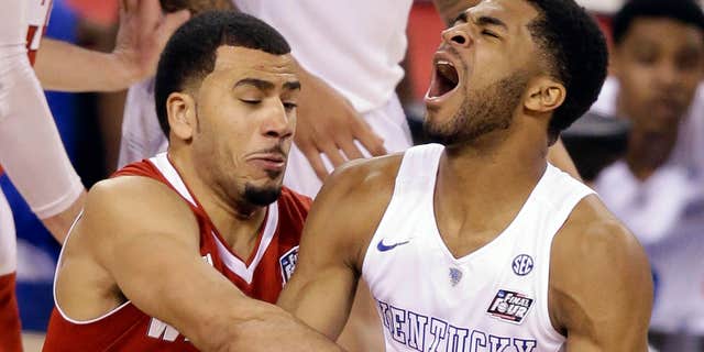 April 5, 2015: Wisconsin's Traevon Jackson (12) fouls Kentucky's Andrew Harrison (5) during the second half of the NCAA Final Four tournament college basketball semifinal game.