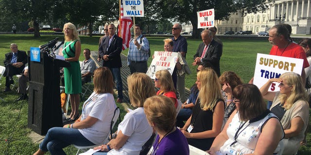 White House counselor Kellyanne Conway speaks on illegal immigrant crime Friday outside the Capitol with "Angel Families."