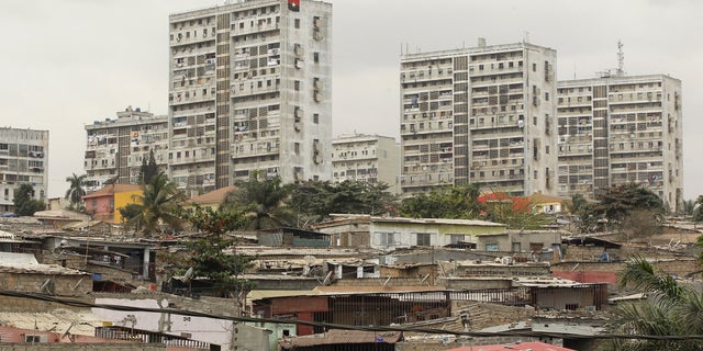 High-rise buildings are seen behind informal settlements in the capital of Luanda, in this August 30, 2012 file photo. REUTERS/Siphiwe Sibeko/Files - RTX2A2MP