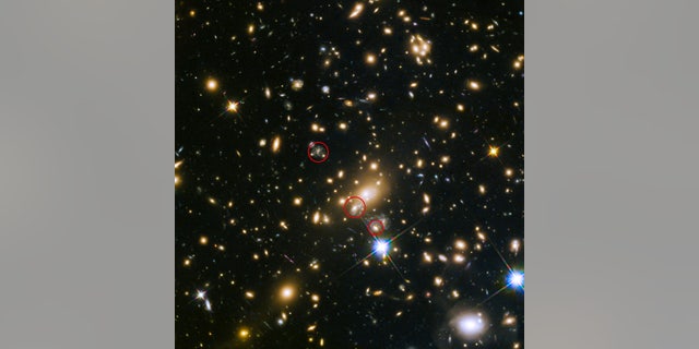 This image shows the appearances of the Refsdal supernova. The uppermost circle shows the position of the supernova as it could have been seen in 1998. The lowermost circle shows the galaxy which lensed the supernova four time â a discovery made in late 2014. The middle circle shows the latest position of the reappearing supernova in 2015.