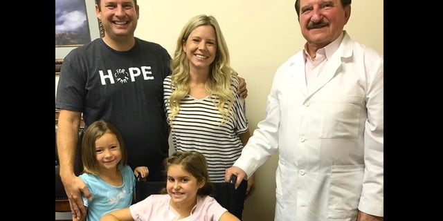 Anna, seated, is pictured with her parents and Dr. Burzynski.